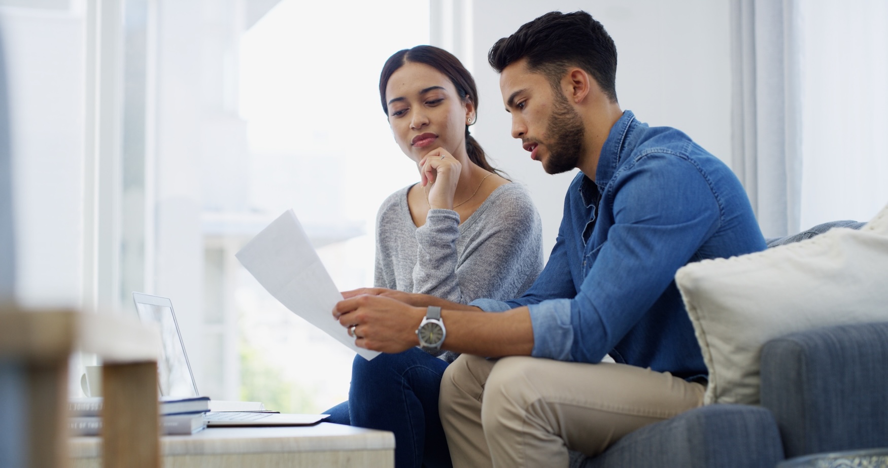 Couple reviewing legal documents together at home.
