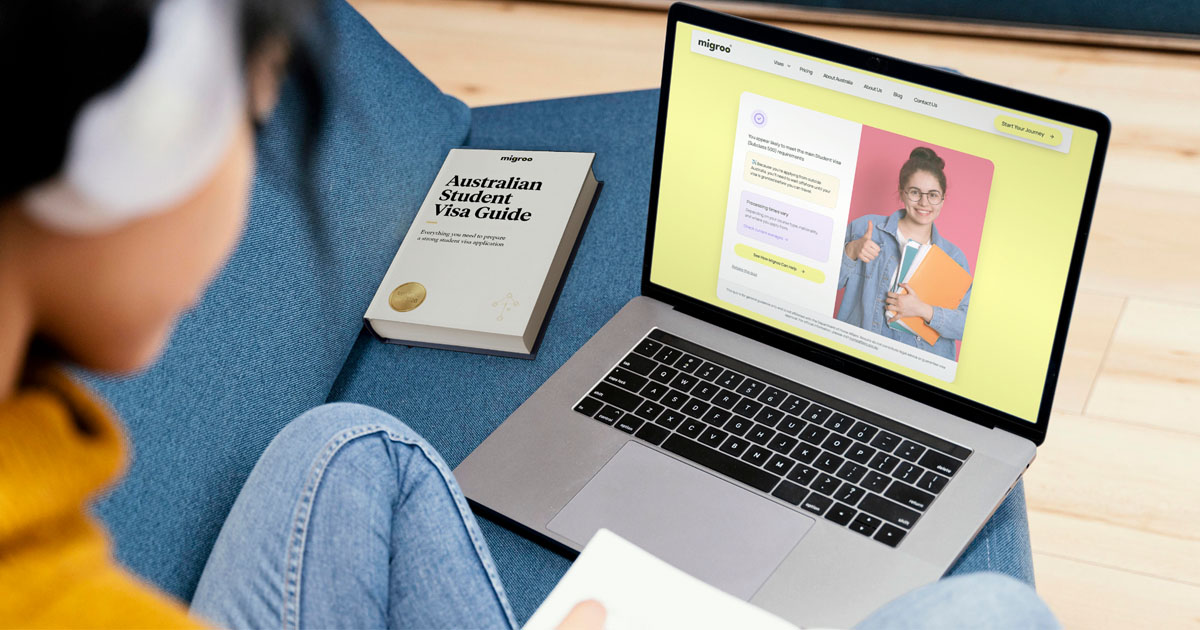 student wearing headphones working on laptop preparing Australian student visa application