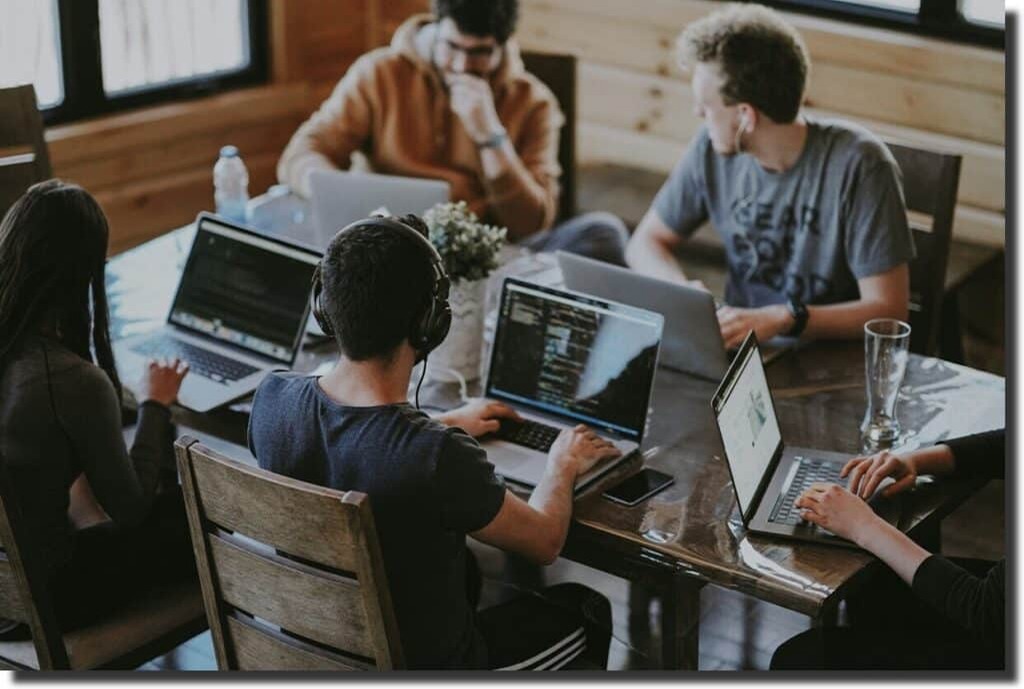 people working in an office at computers