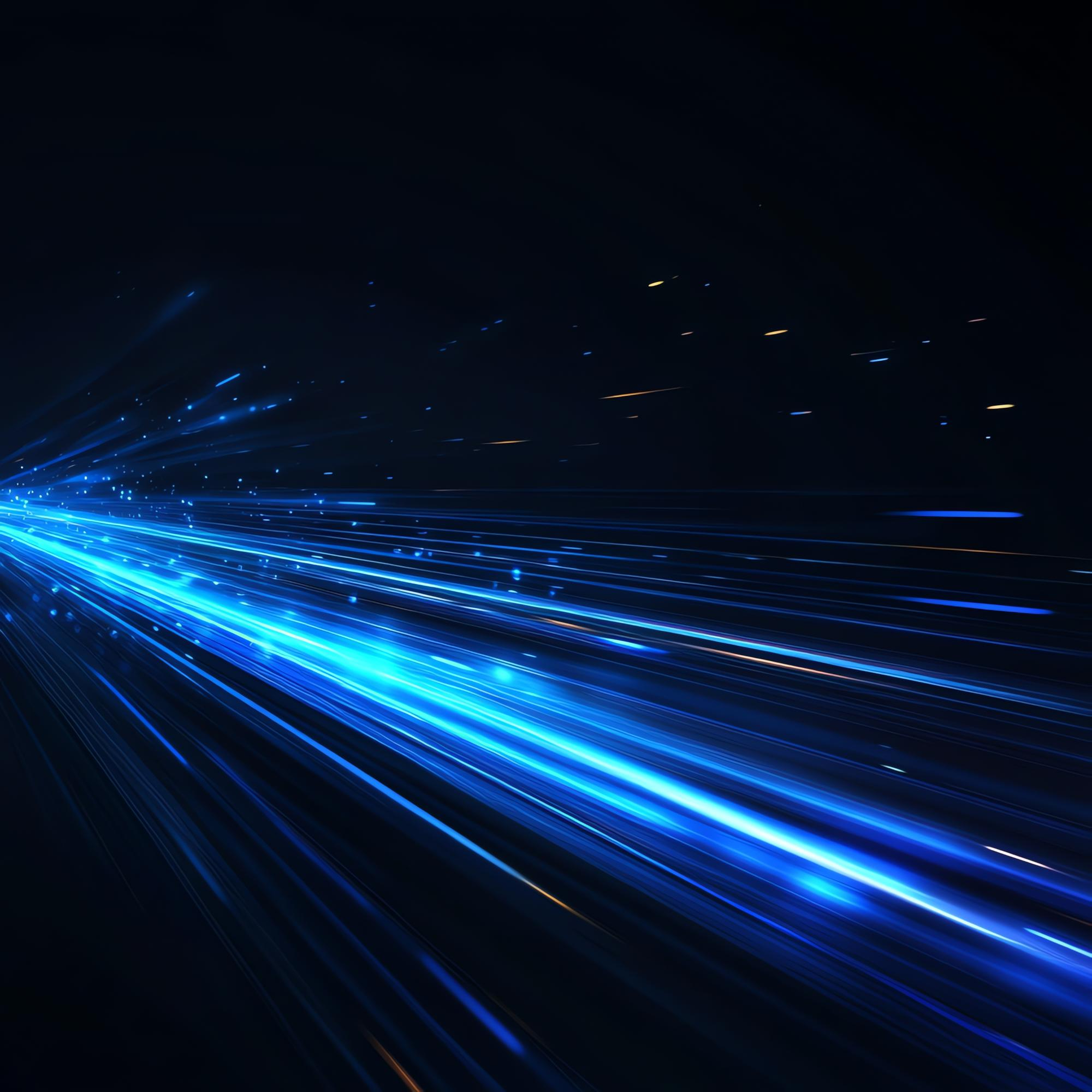 Bright blue light streaks radiating from the left side on a dark background, resembling high-speed motion or data transmission.