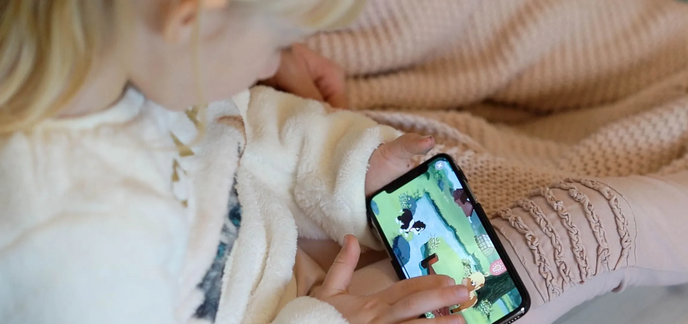 A woman holding a cell phone in her hands.