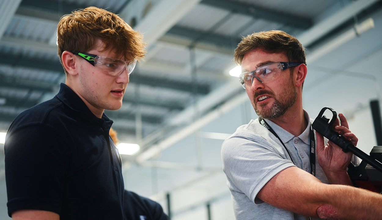 Senior colleague showing a junior team member how to do something