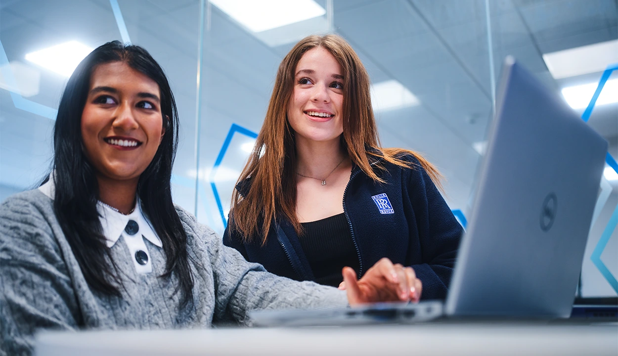 Two female co-workers collaborating on a laptop