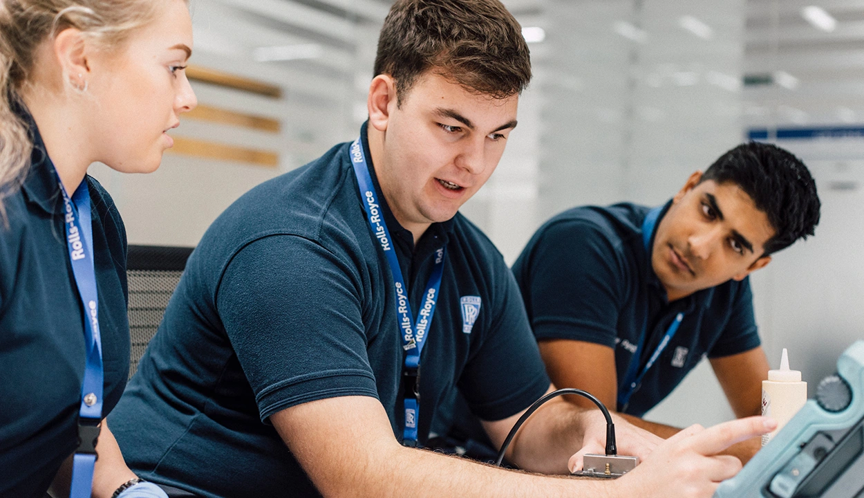 Three co-workers working through a task together