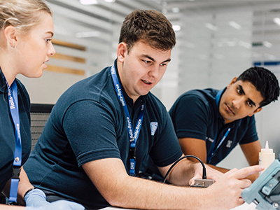 Three co-workers working through a task together
