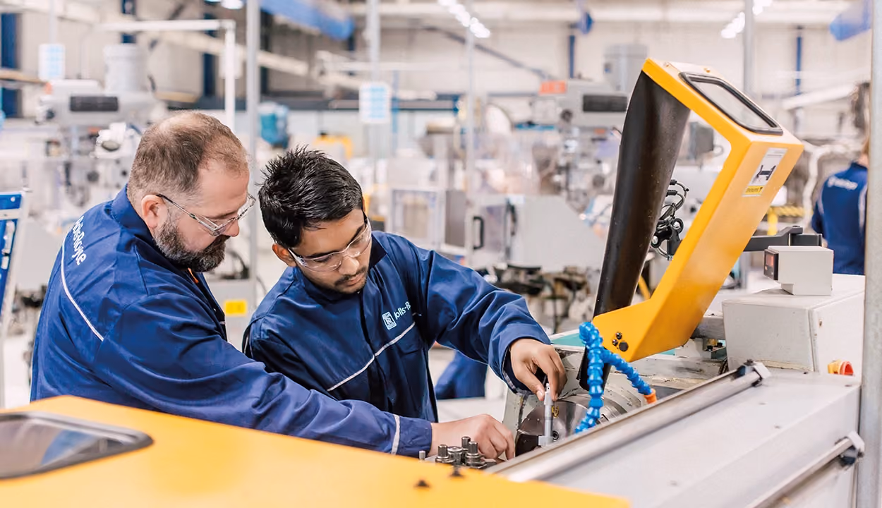 Two engineers working together on an engine