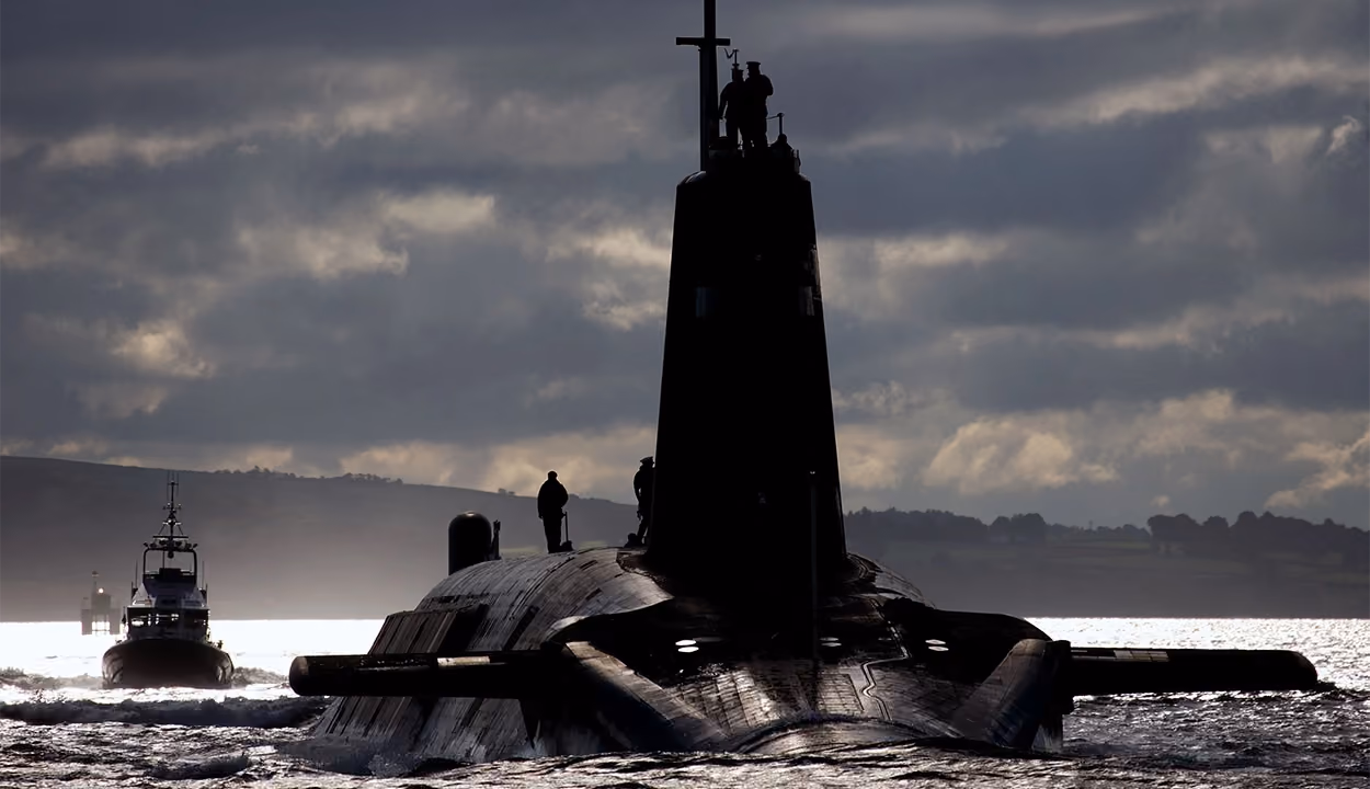 Submarine sailing on the surface of the sea with people looking out