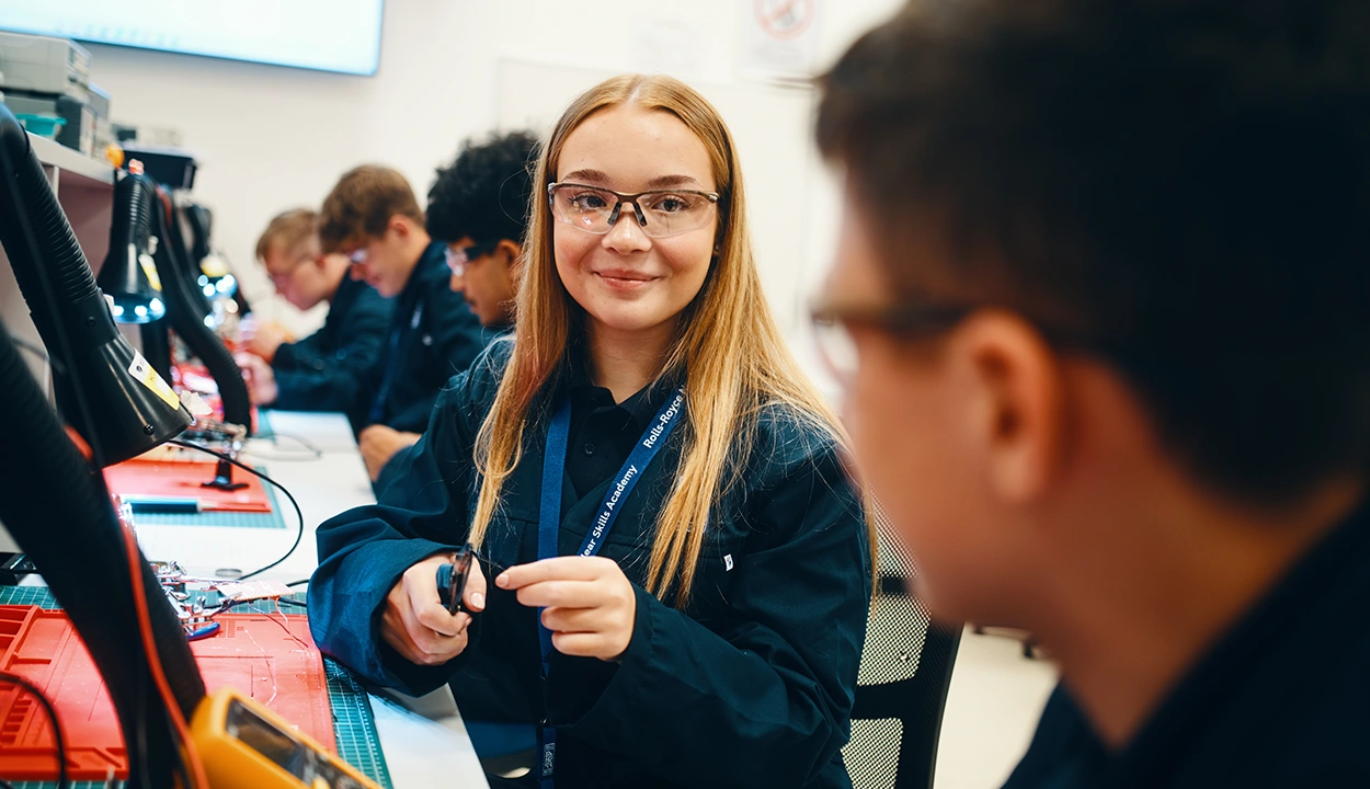 Female worker testing products and smiling to the camera