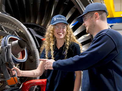 One co-worker explaining how to solve a problem to another