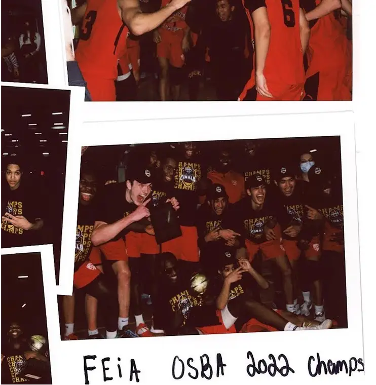 A basketball team celebrates with a trophy, wearing matching red uniforms labeled "Champs 2022."
