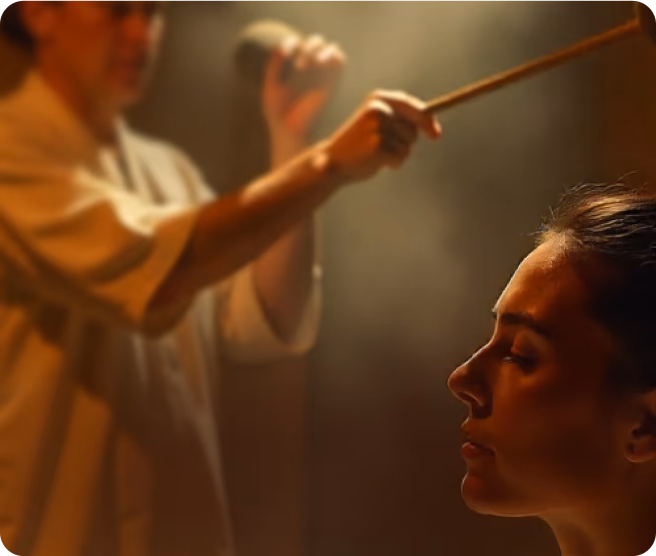 Person receiving sound therapy with a gong or chime, featured in the Sound Sauna at the Toronto Sauna Festival
