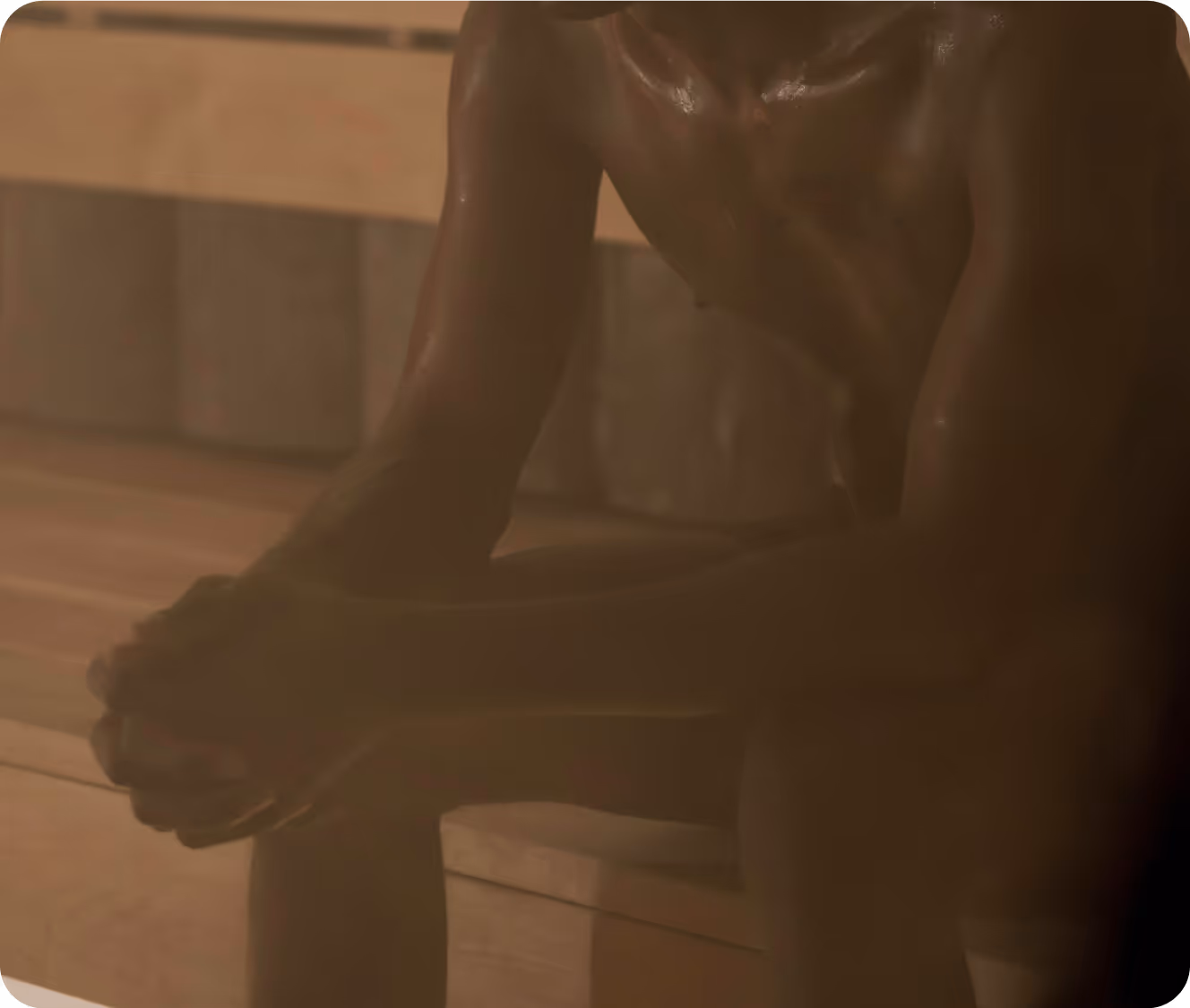 Person seated alone in a sauna, representing the Free Sauna offering unstructured heat experiences at Toronto Sauna Festival