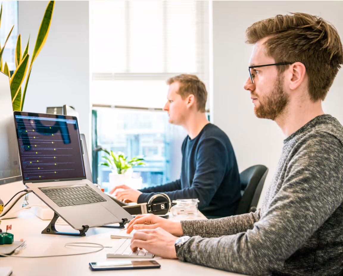 Two people working on a computer