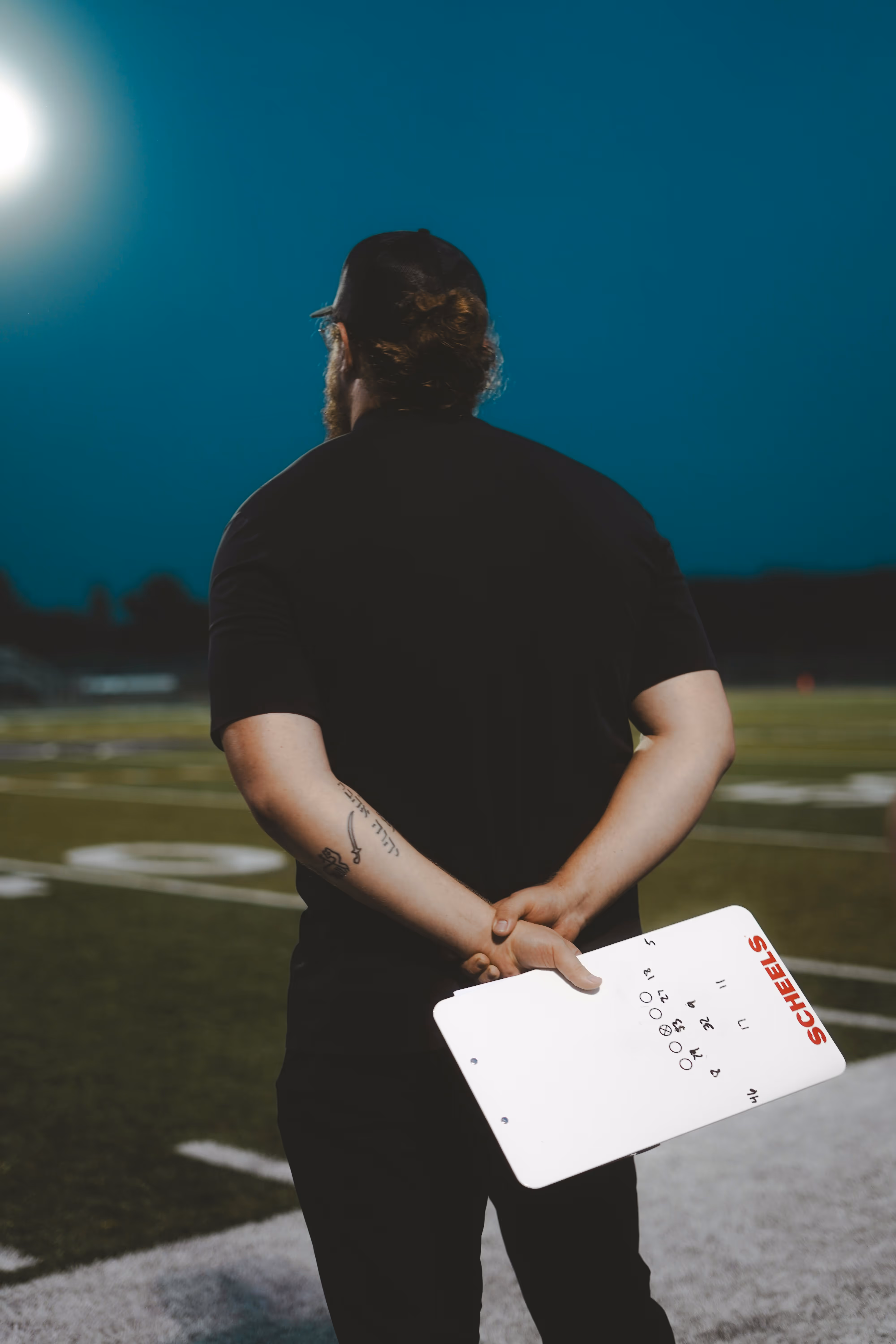image of a coach holding a clipboard