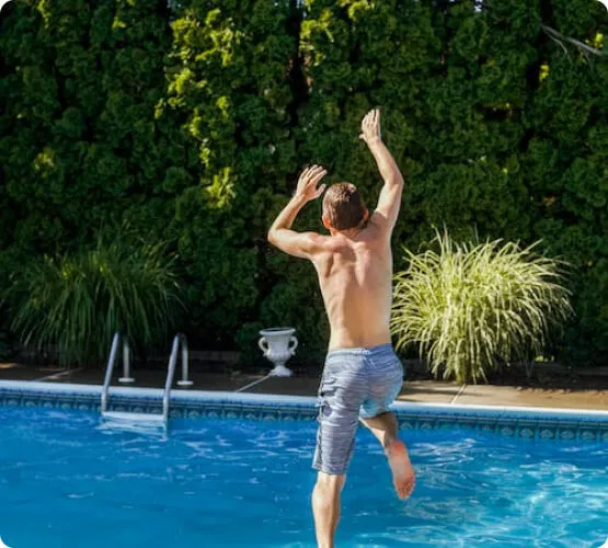 Our mission section image for pools ETC showing a man jumping into a clean pool