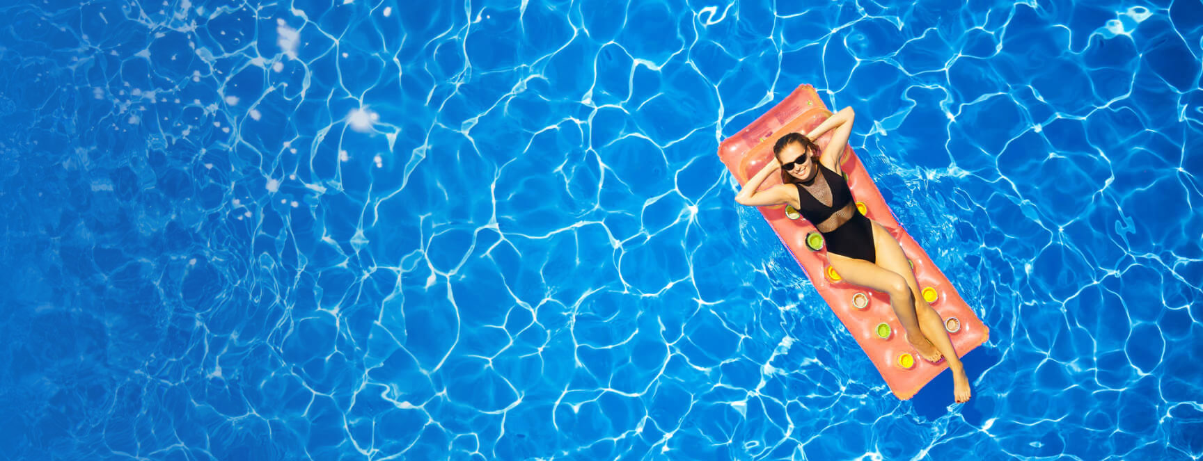 Image of a crystal clear pool that was professionally cleaned and maintained and the a customer enjoying relaxing on a pink float