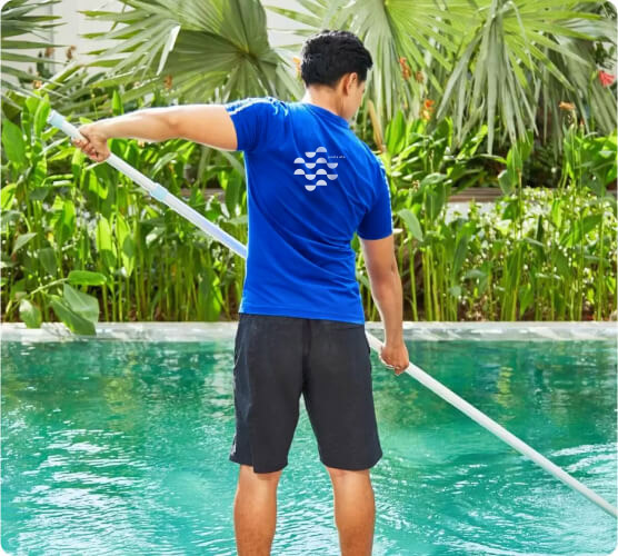 pools ETC team photo showing an employee maintaining a pool