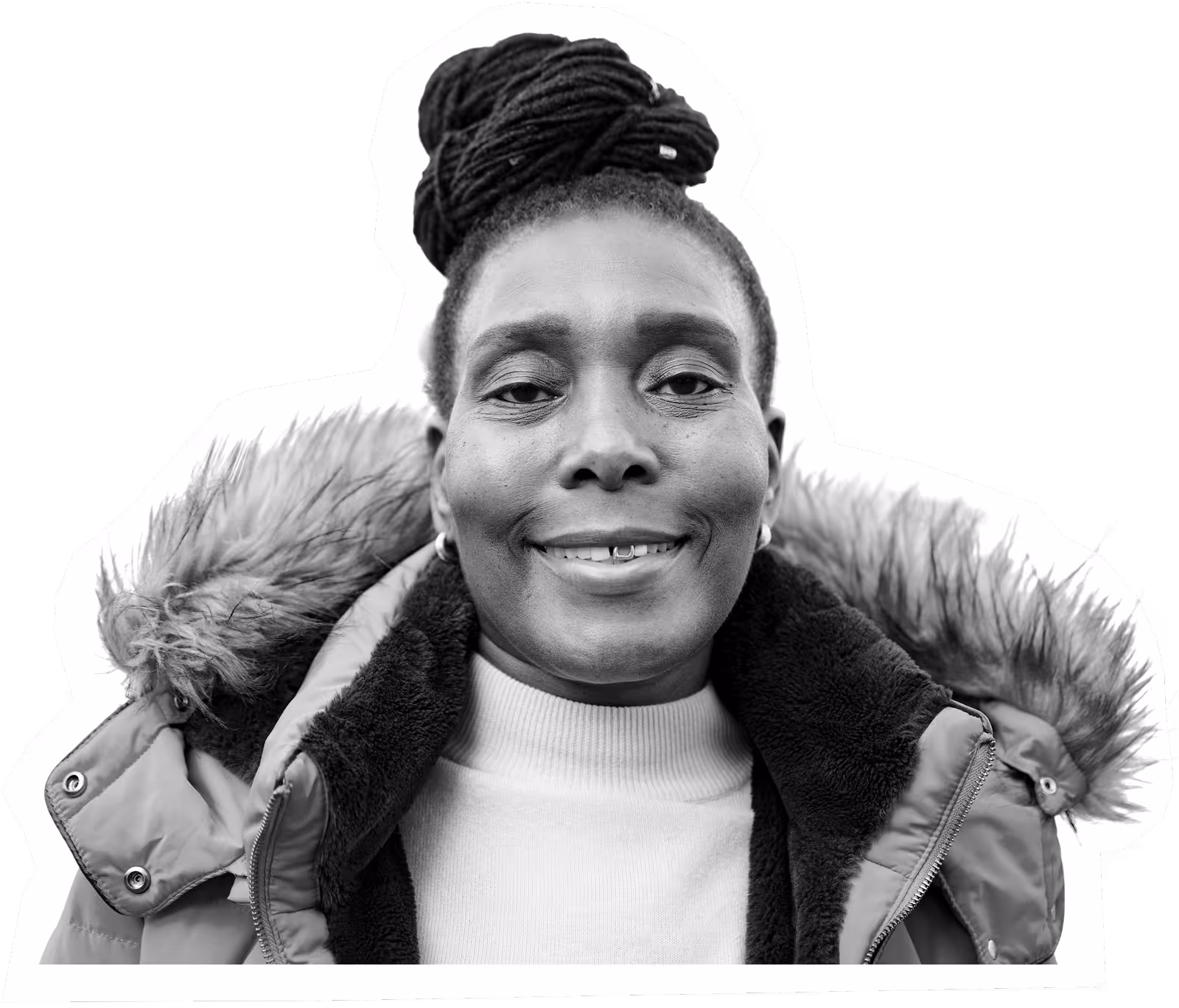 Smiling person in winter coat with fur hood and top knot hairstyle