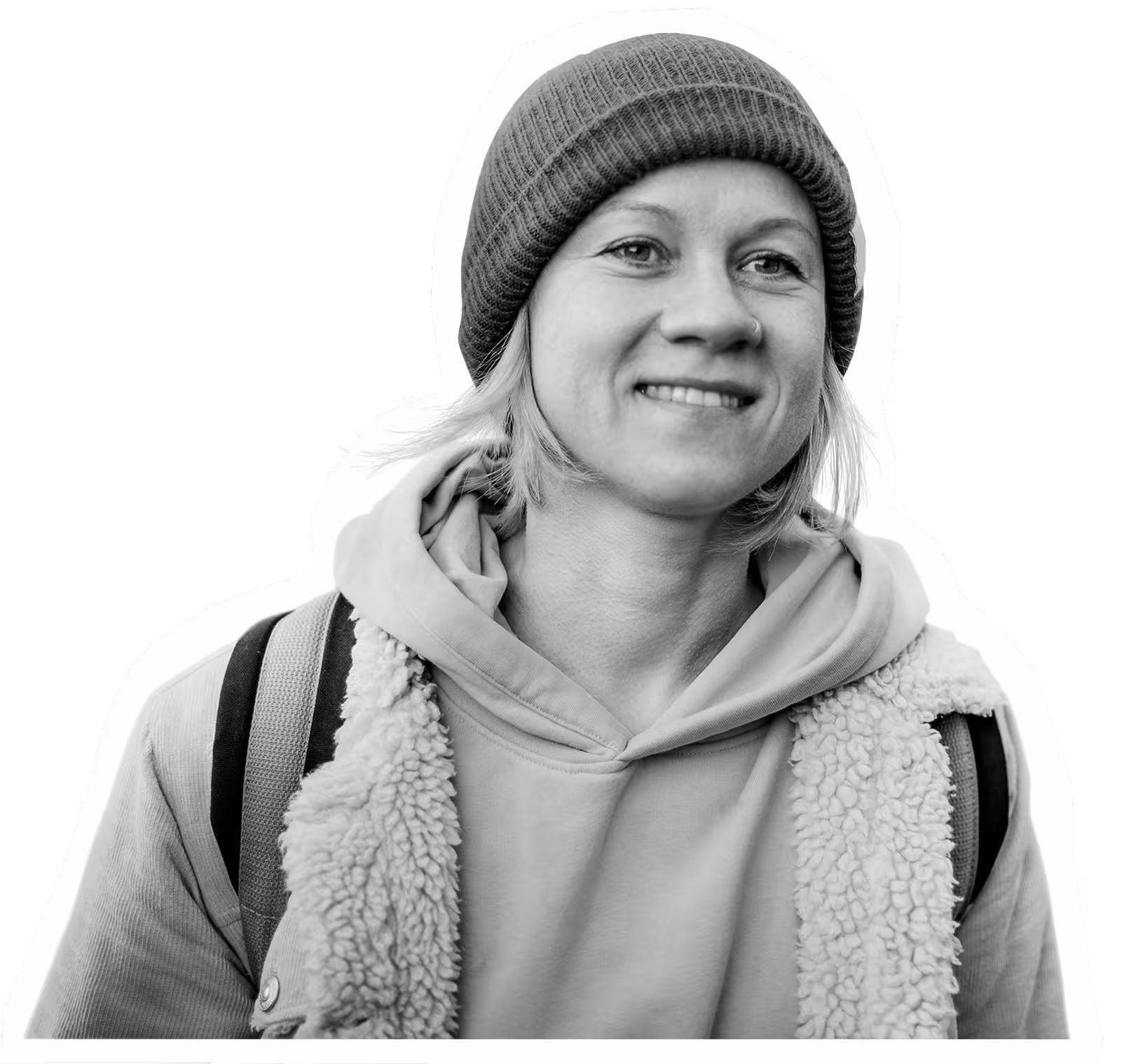 Smiling person in warm winter clothing with beanie and fuzzy vest