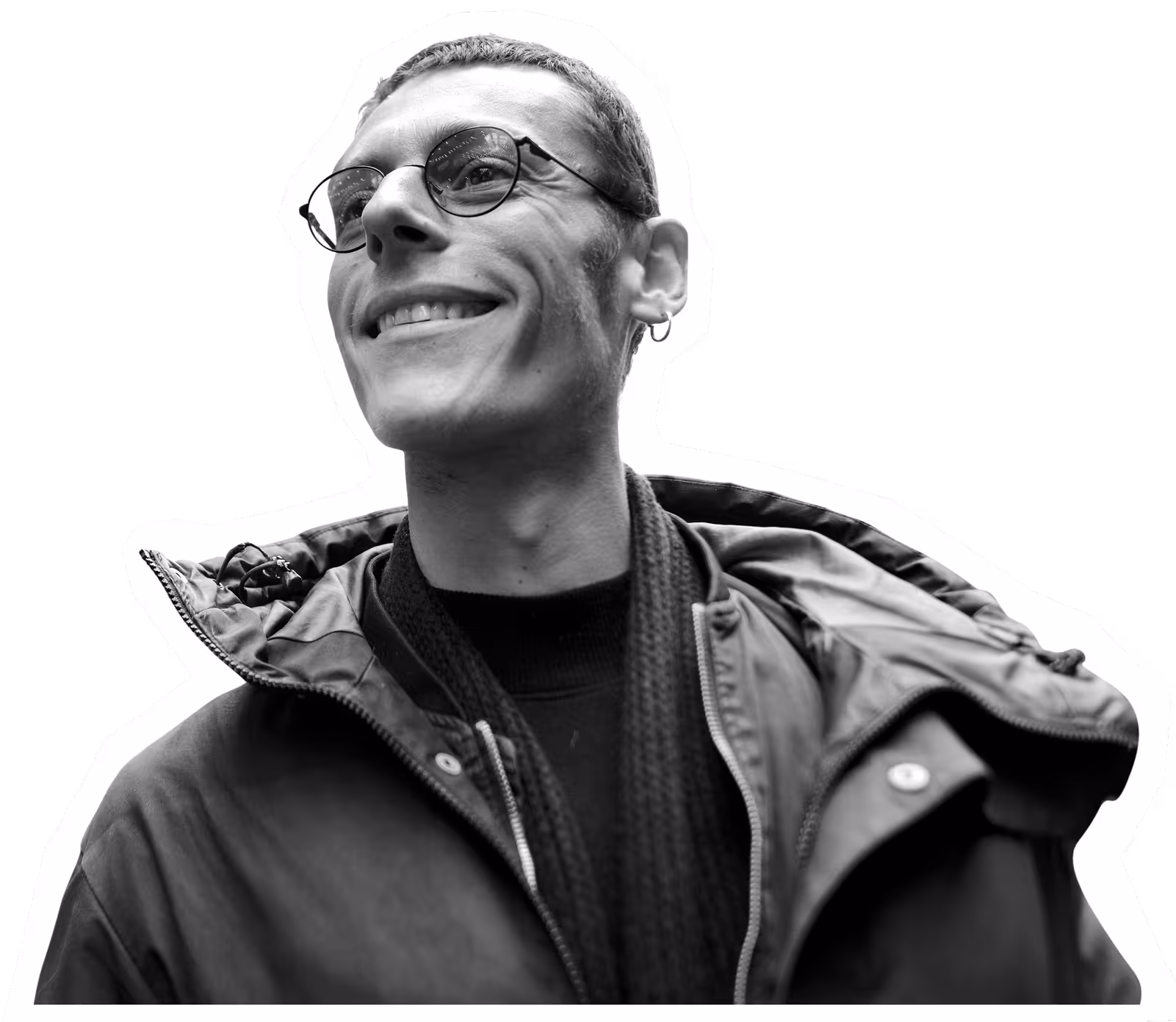 Black and white portrait of smiling person in glasses and jacket