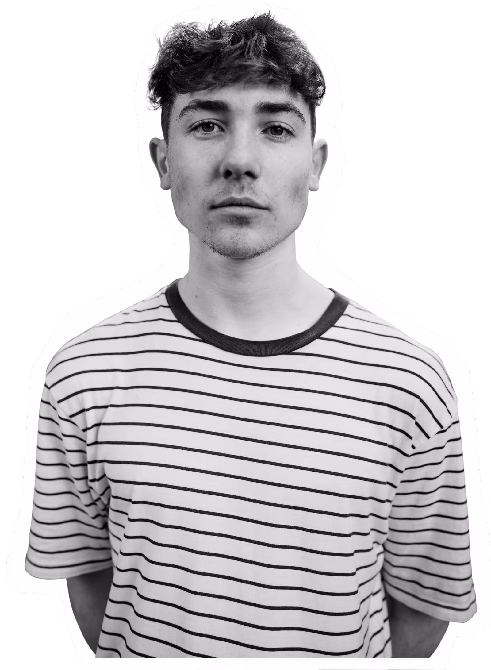 Young person in striped shirt looking directly at camera in black and white