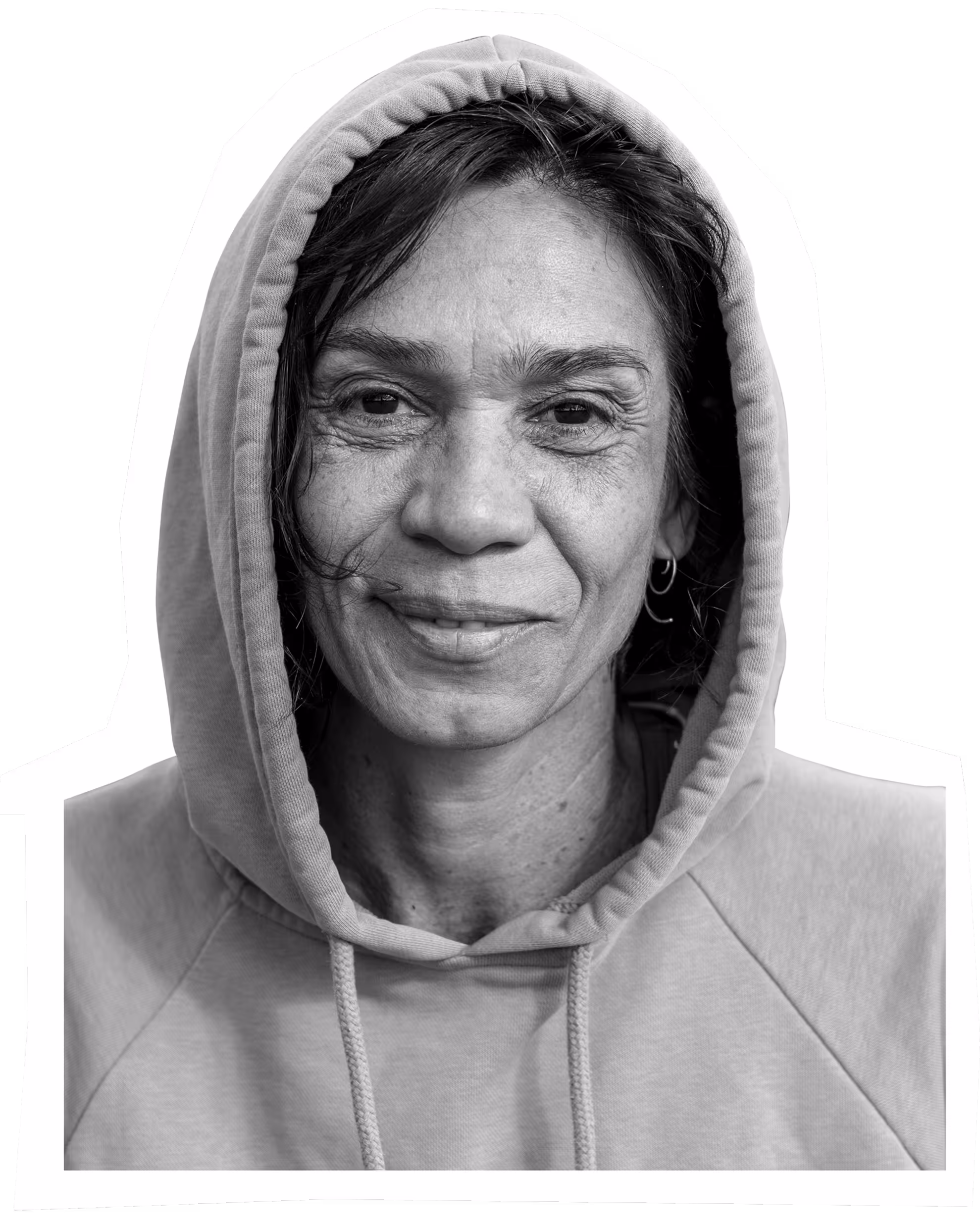Smiling person in gray hoodie, black and white portrait with warm expression