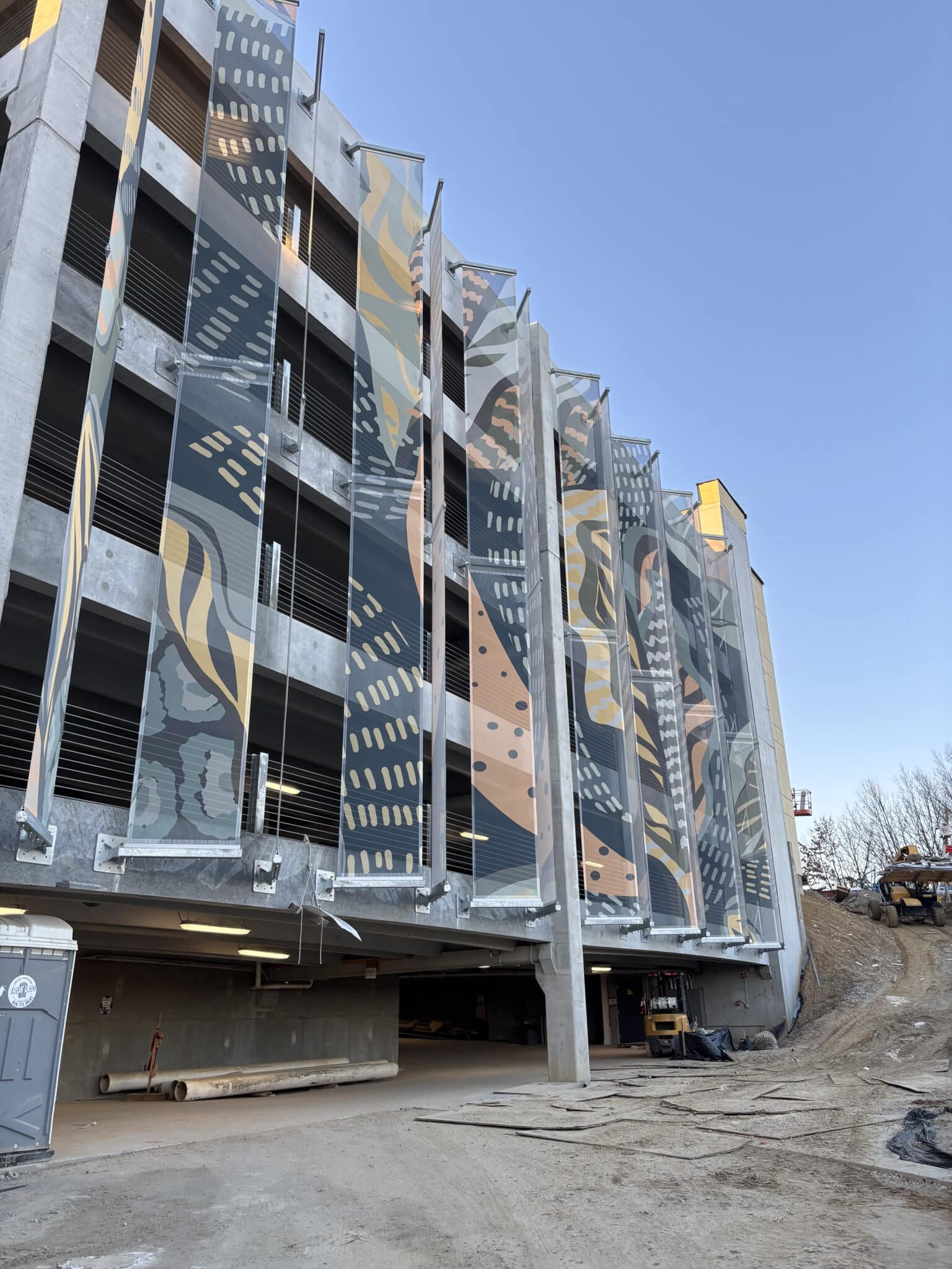 Slotted angled facade with abstract graphic elements.