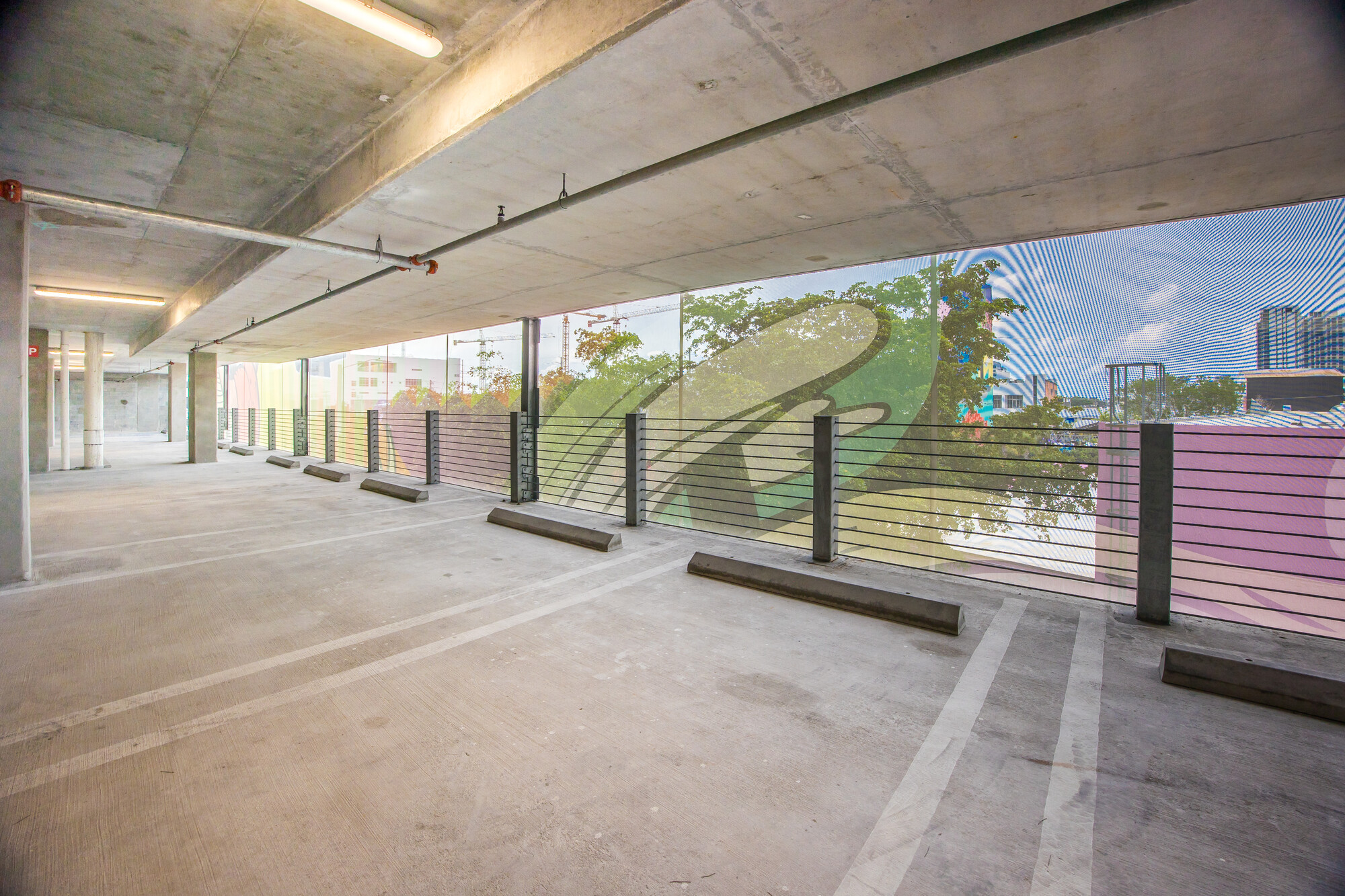 A view from inside of the garage looking out through the facade.