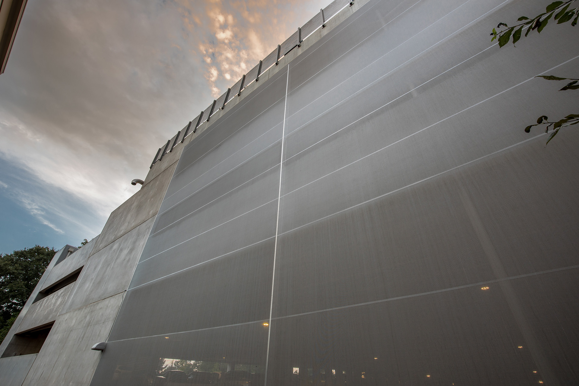 A simple gray facade sat on the face of a parking structure.
