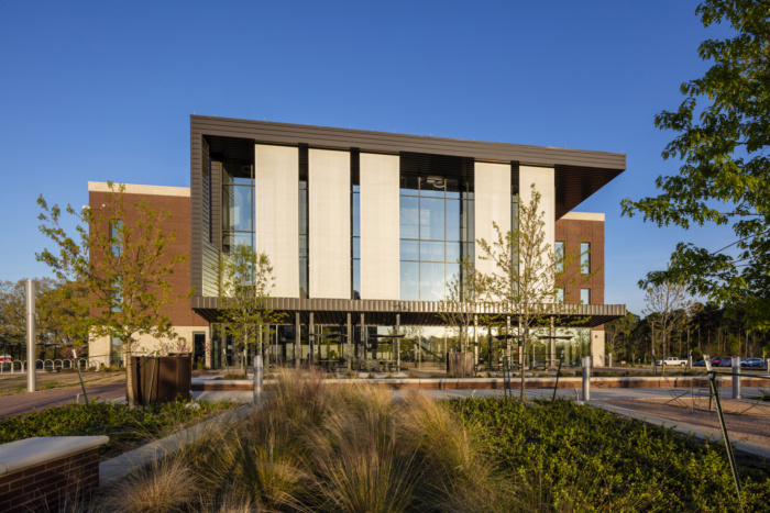 White paneled facade that sit multiple feet away from the building to still give it an open feel.
