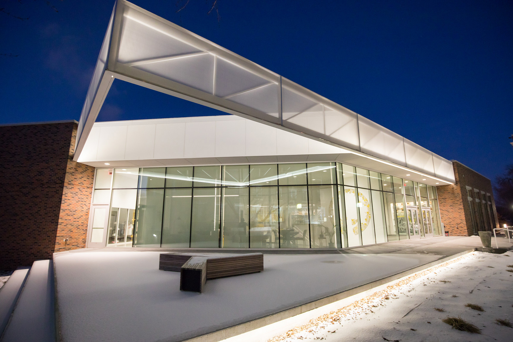 A triangular shaped facade that jets out over the entrance of a school to provide light in the immediate area.