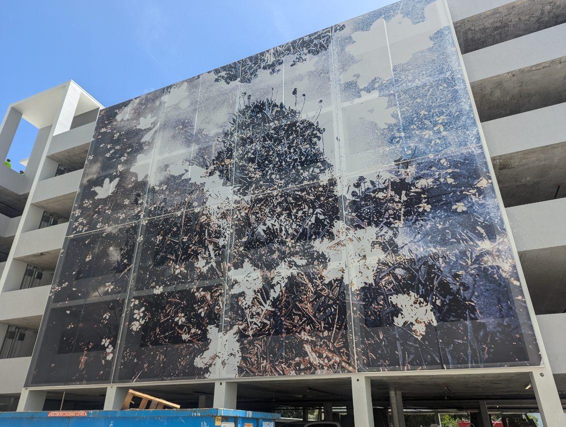 A black and white graphic facade with printed artistry featuring a floral motif.