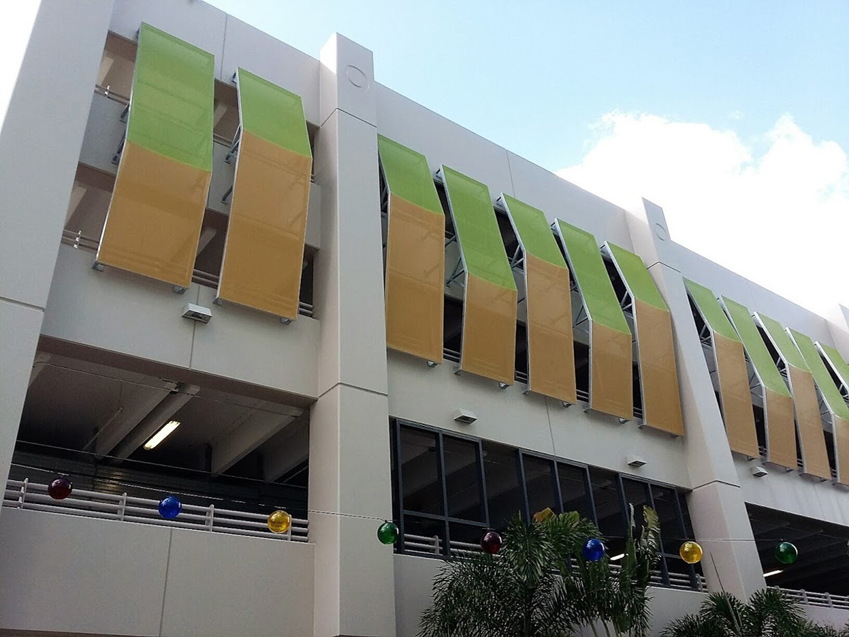 A green and orange paneled facade with the panel shape resembling arrow points.