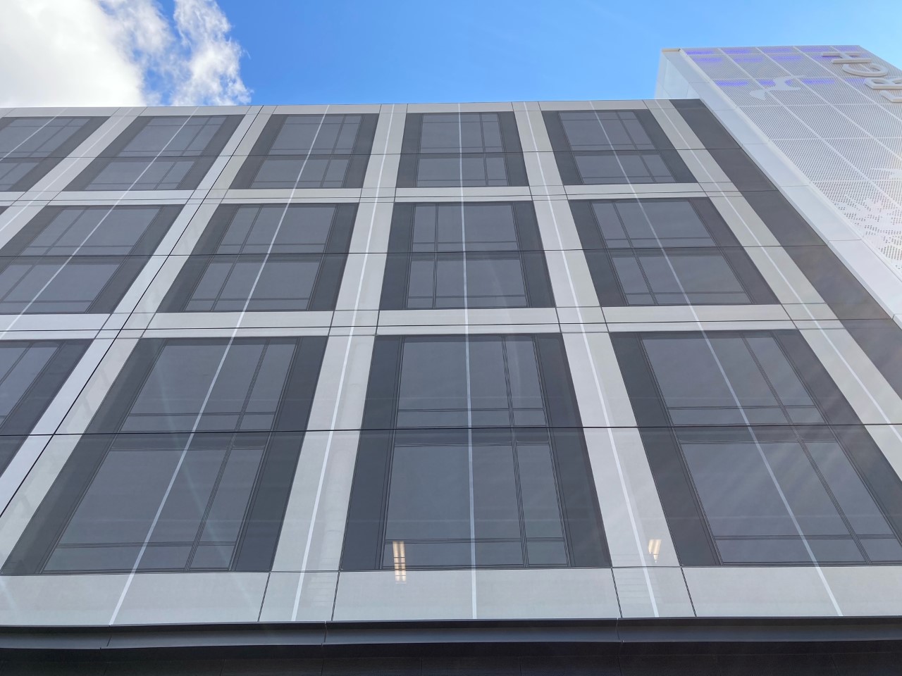 Gray Cladding Screens that are flush with surface of the parking structure.
