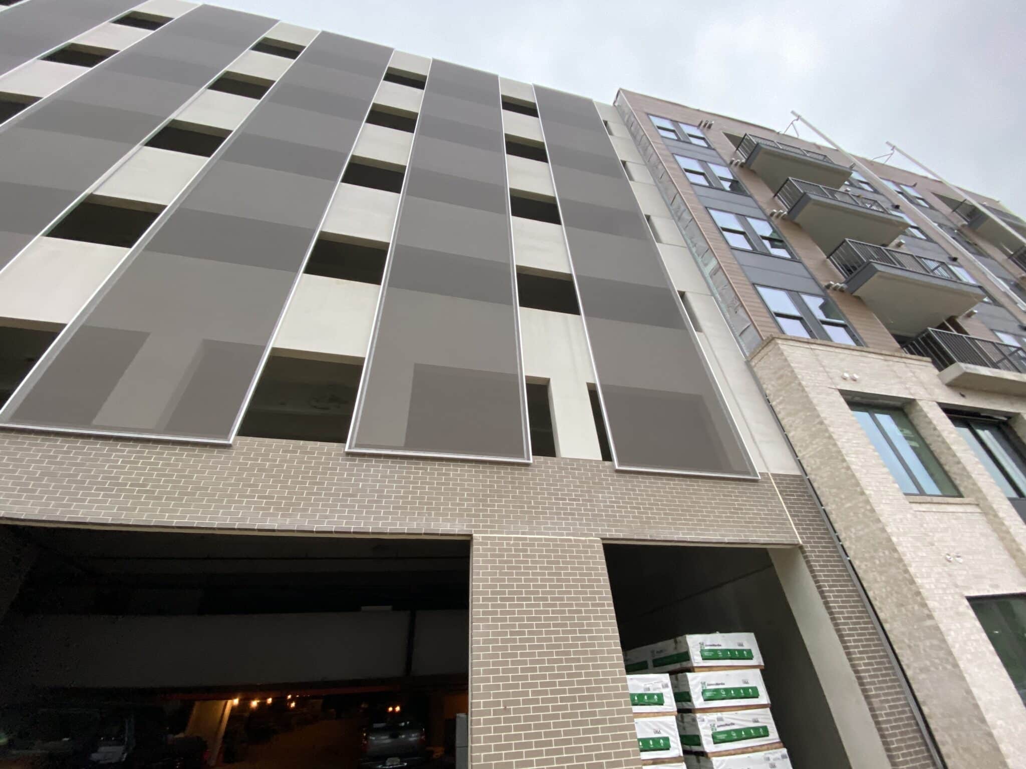 A gray slotted Cladding Screens parking garage facade.