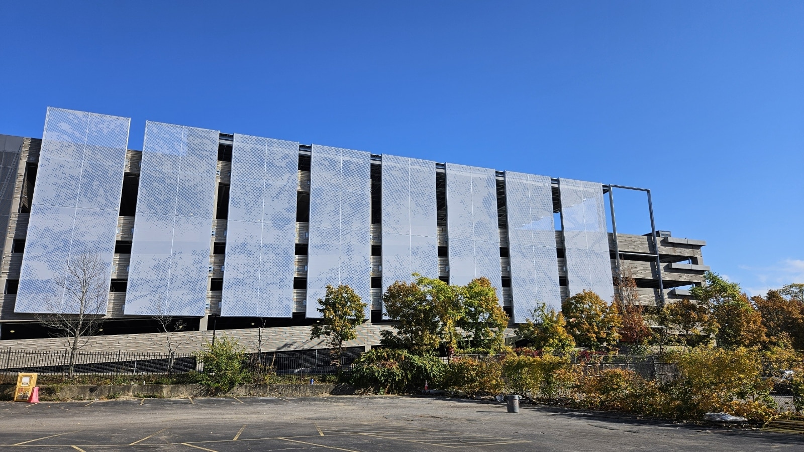 A blue pointillism style graphic facade that mimics the pattern of tree branches.