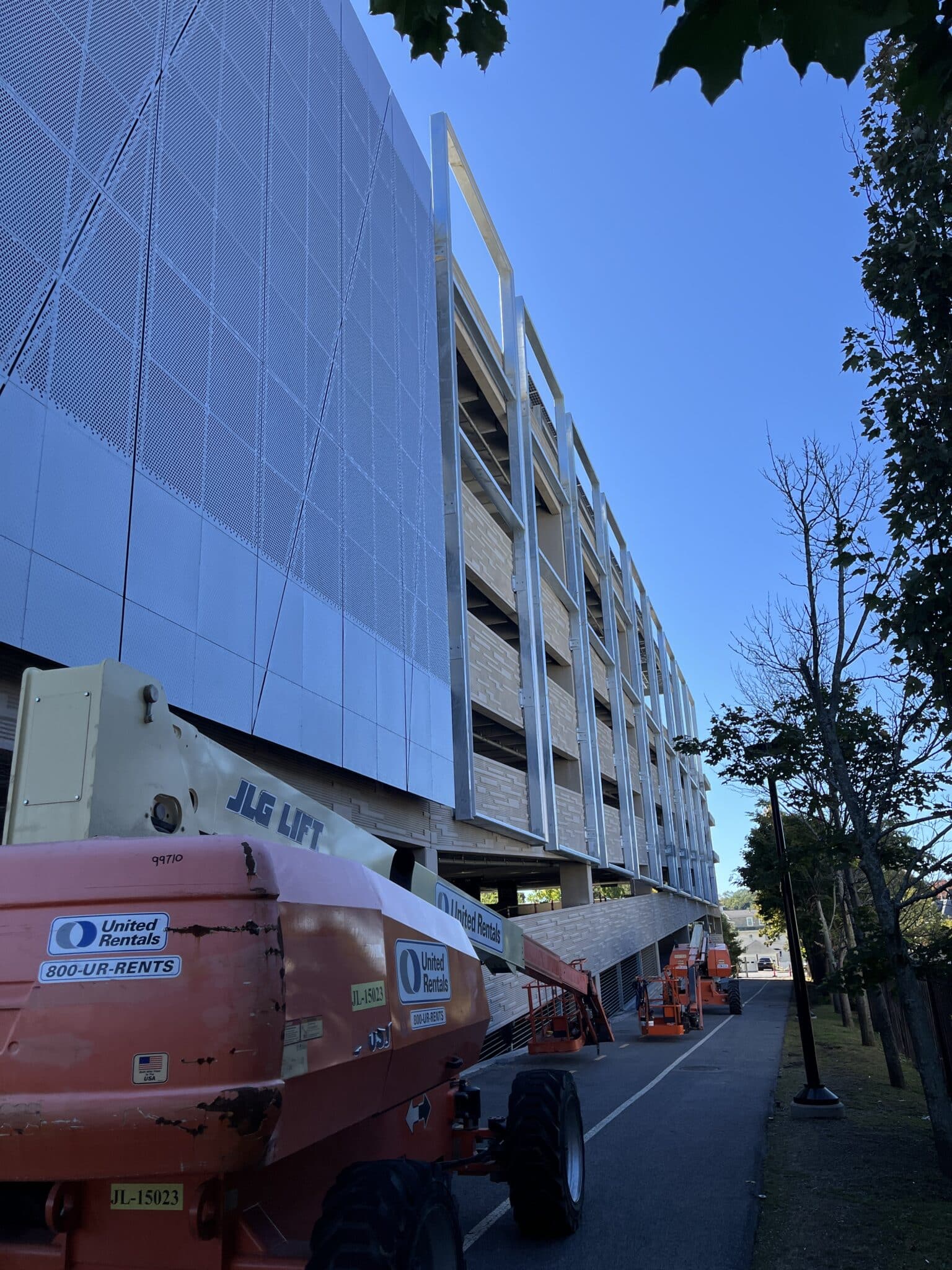 A photo of the facade being installed onto the steel frames.