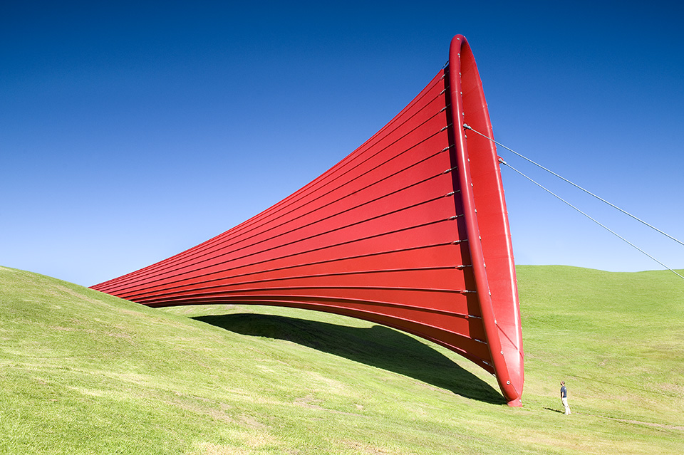 A red cone shaped sculpture designed by Anish Kapoor made out of a PES waterproof membrane.