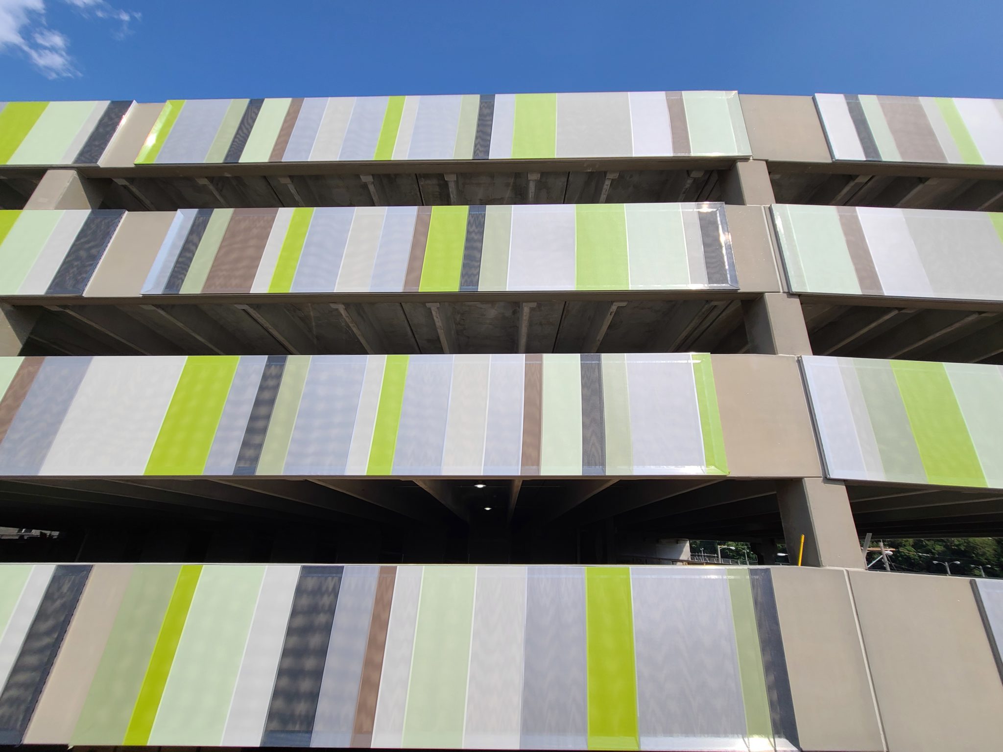 A sidewalk shot of the facade showing a realistic scale of the size.