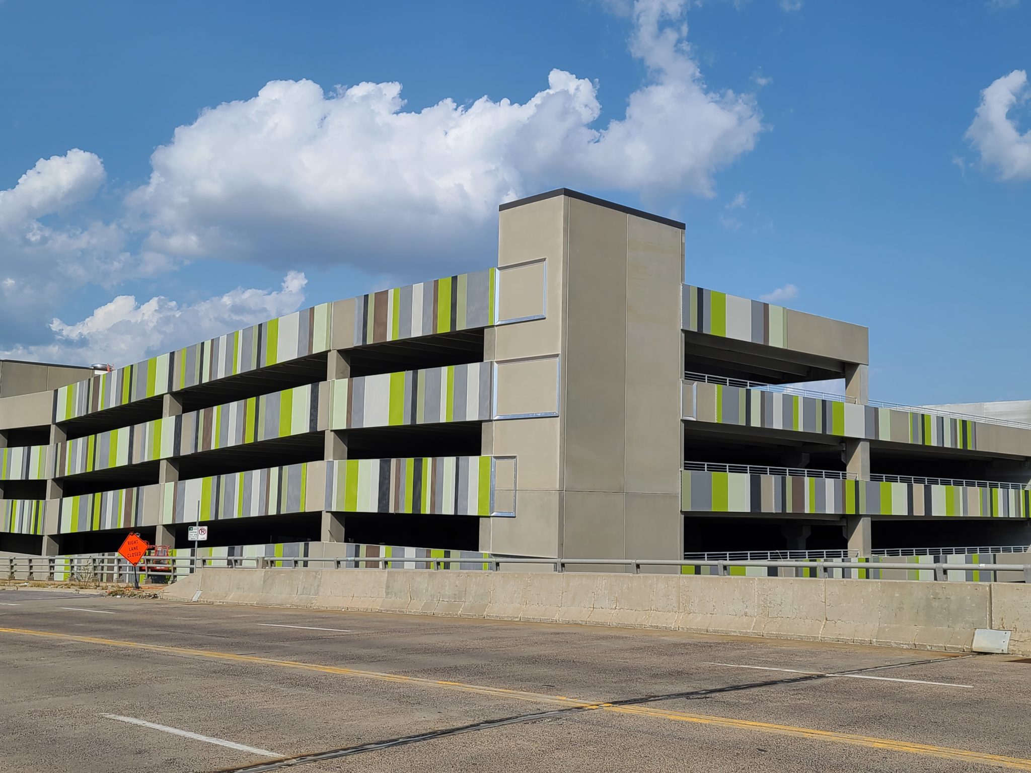 A wide angle view of the facade, showign it wrap around the corner of the parking structure.