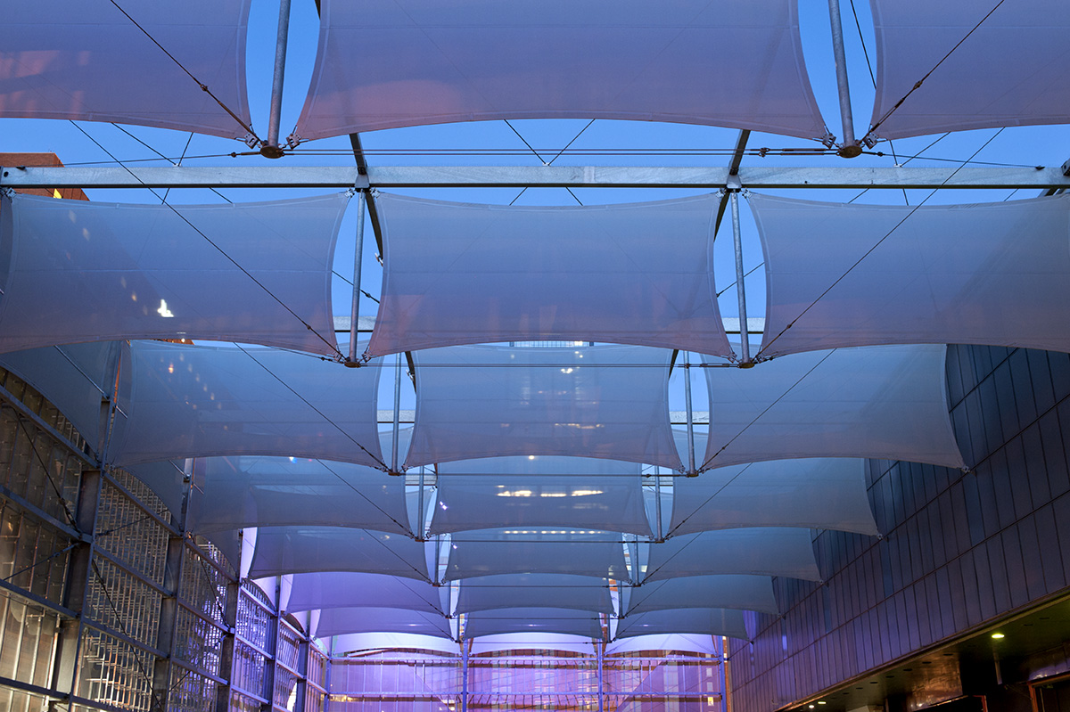 A view of the facade panels at night.