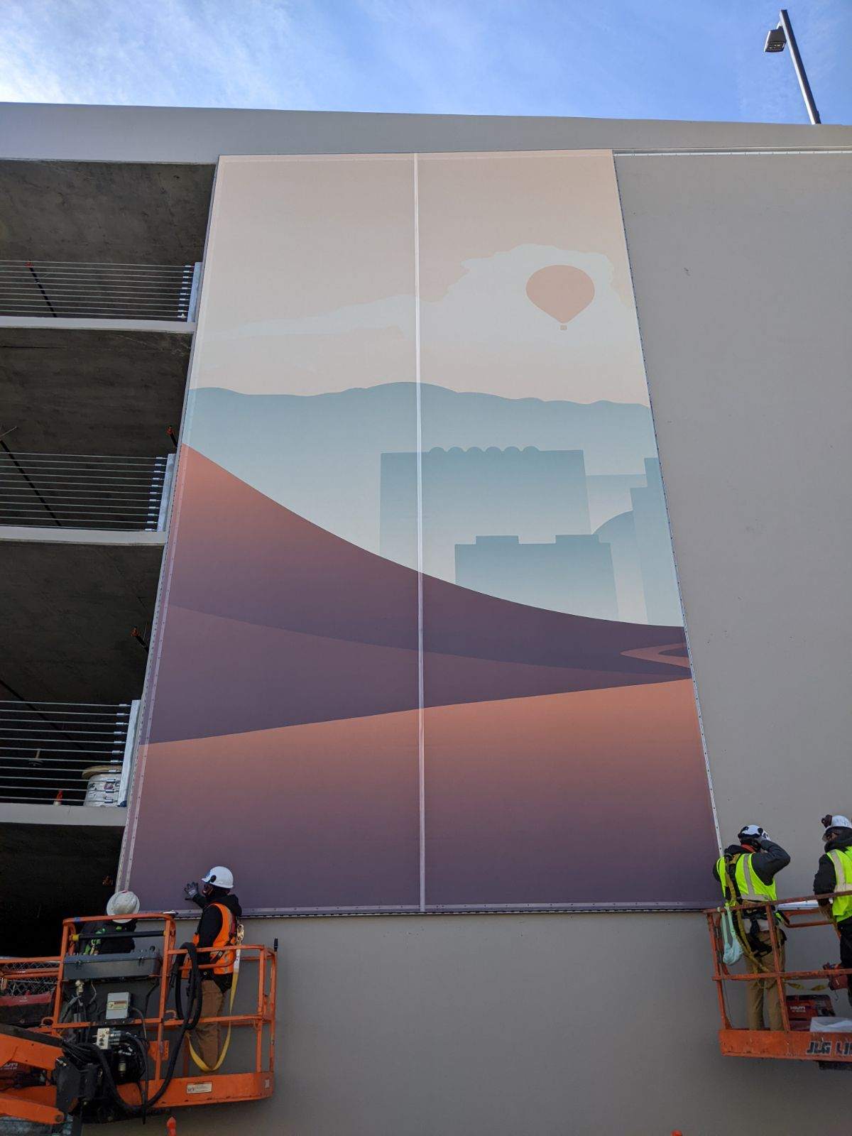 A process photo of the facade being installed.