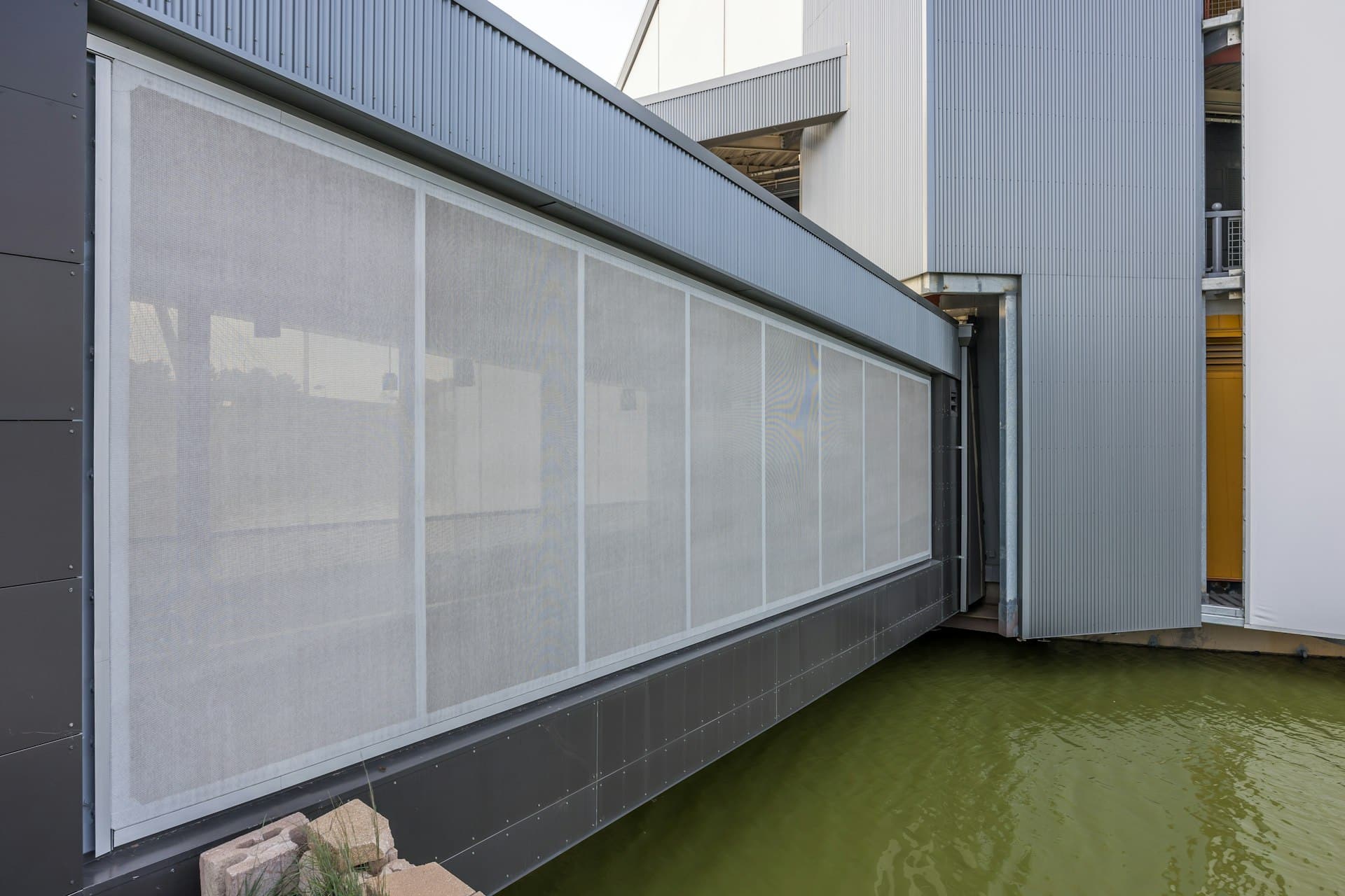 An image of the other side of the facade that is a thin white 2D Cladding on Steel.