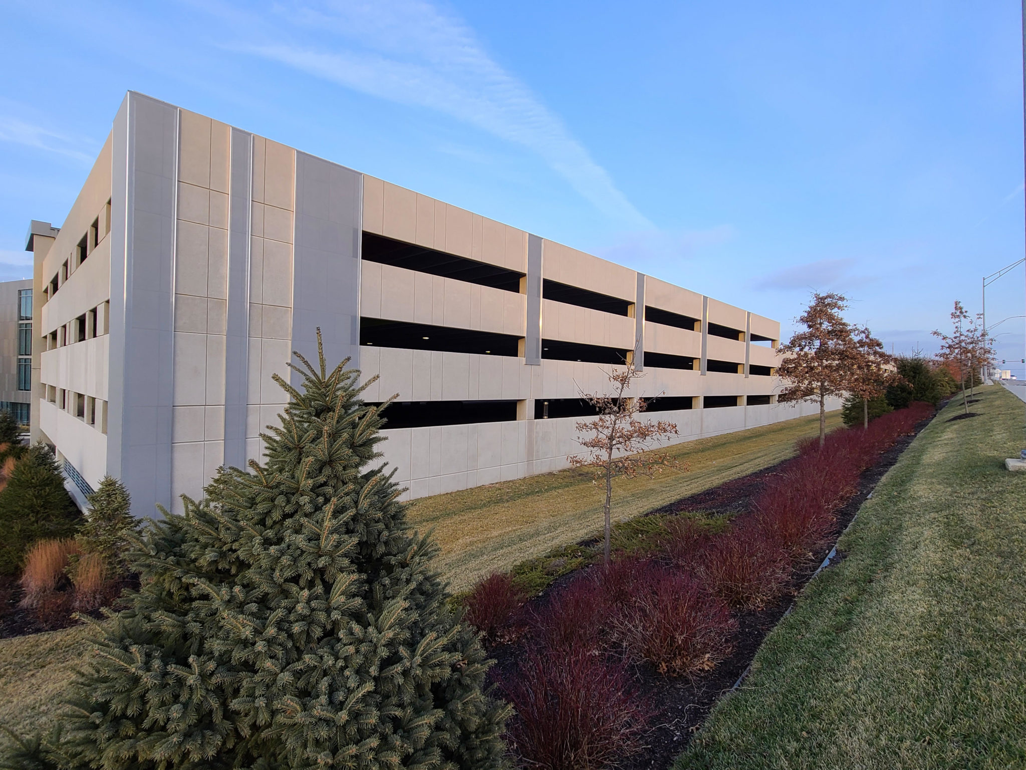 Wide view of the facade covering small parts of the parking garage.