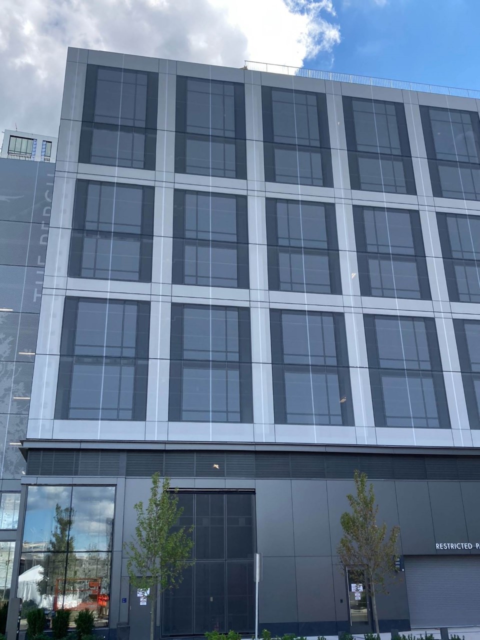 Grey Ventilated PES Cladding Screens flush with the facade.