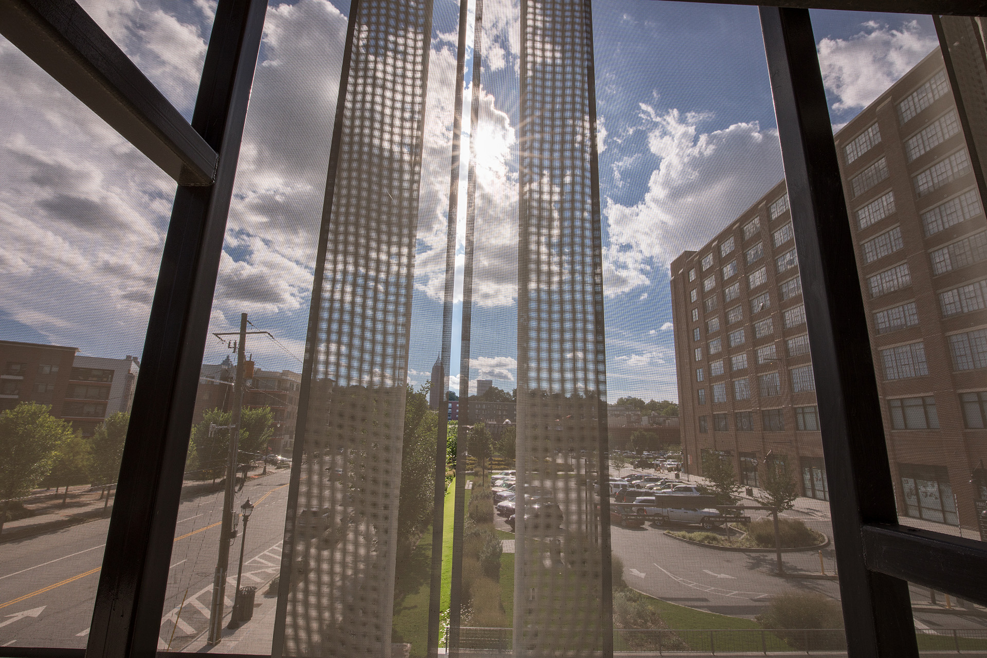 A view from inside of the parking structure looking out through the facade.