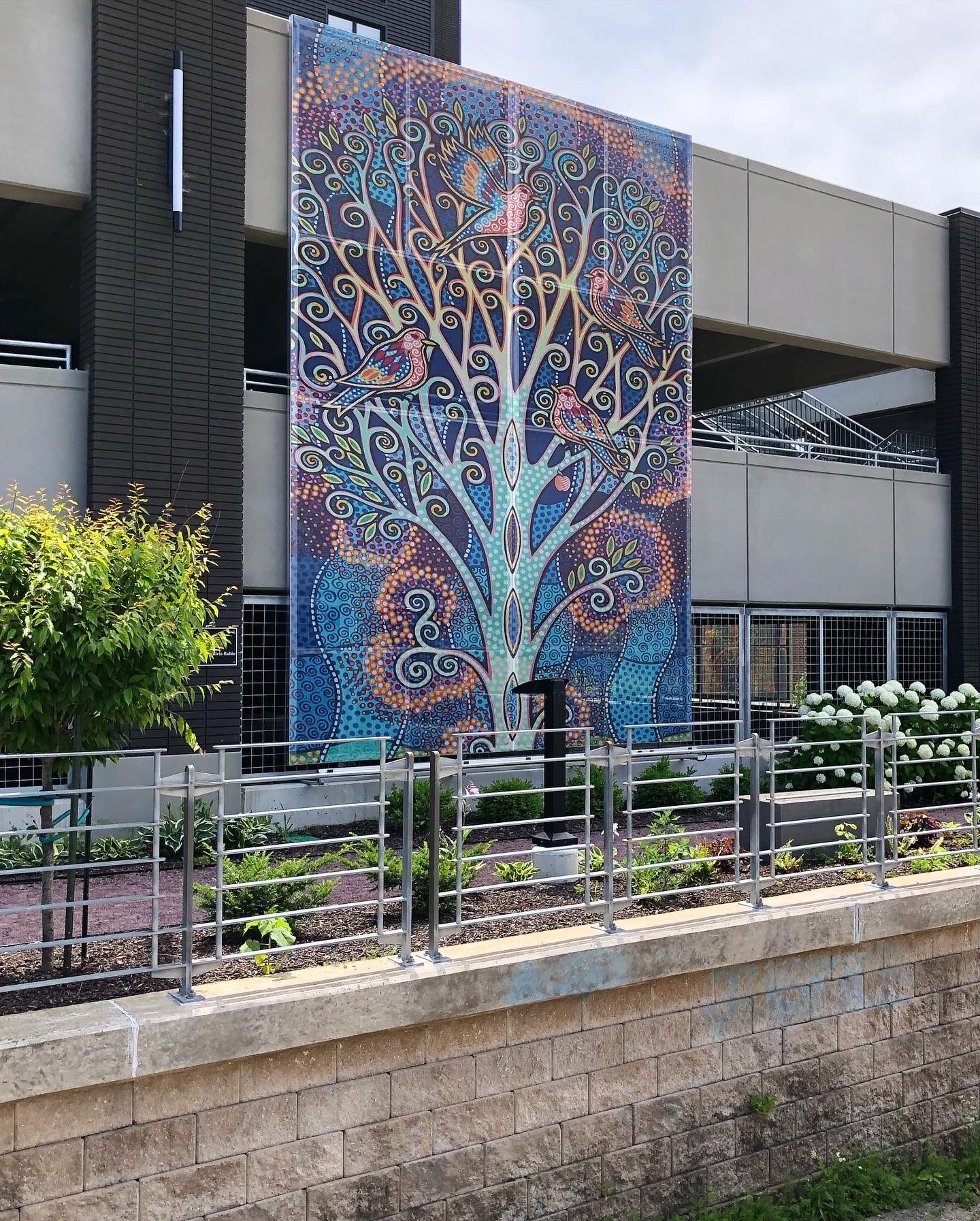 The rainbow tree graphic facade from across the street.