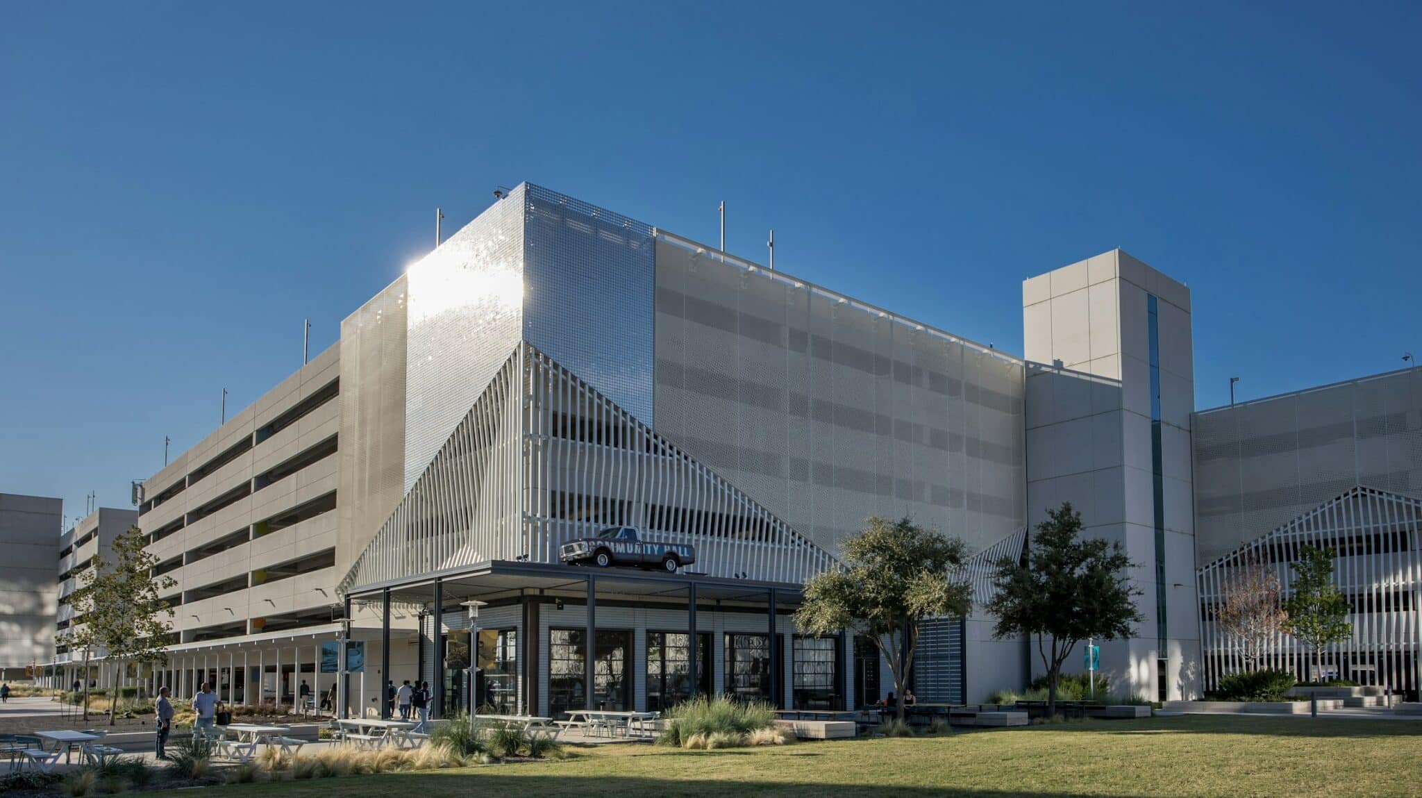 A wide shot of the entrance of the building with the facade on top.