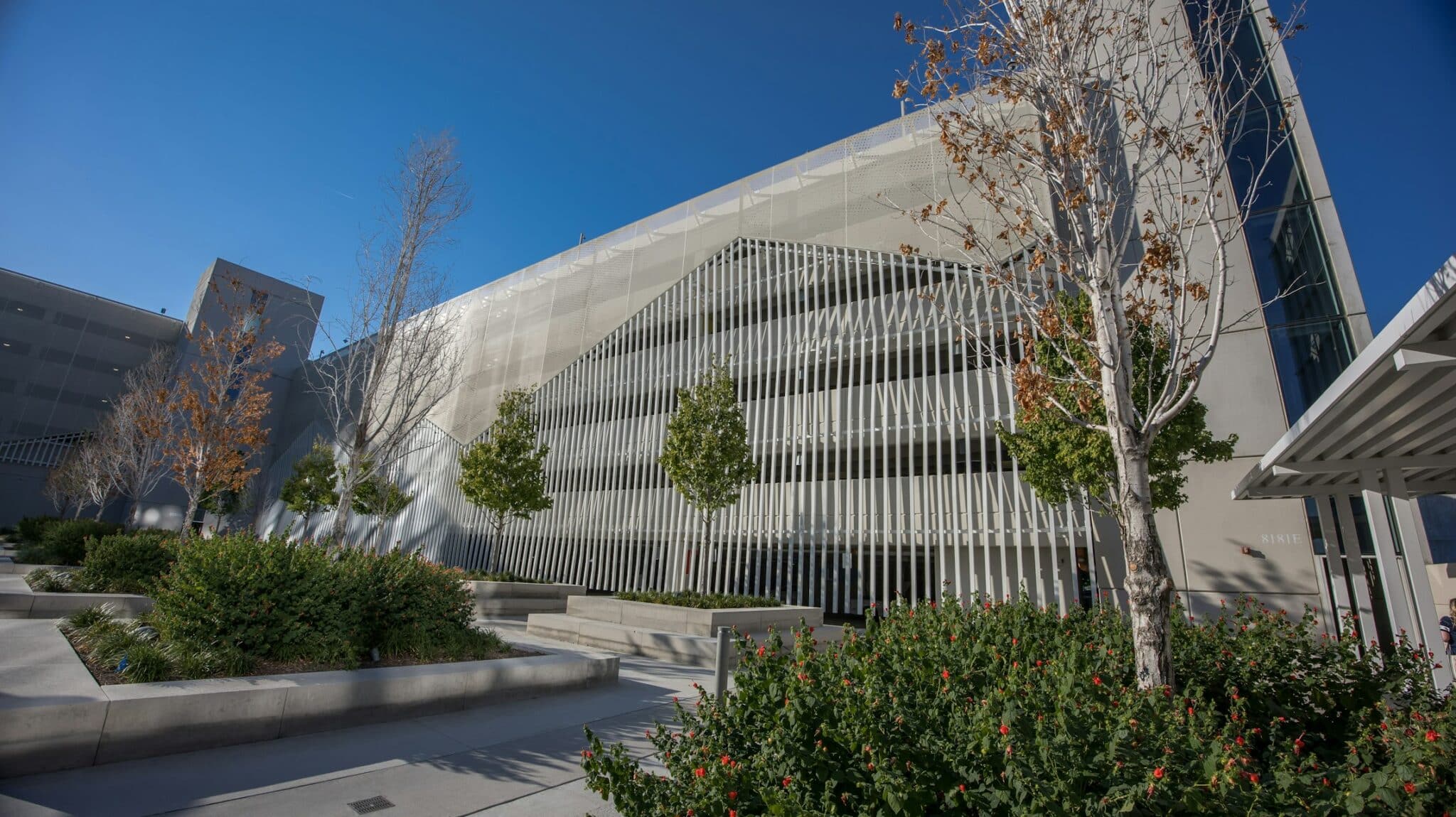 A wide shot of the parking structure with the mountainous facade overtop.