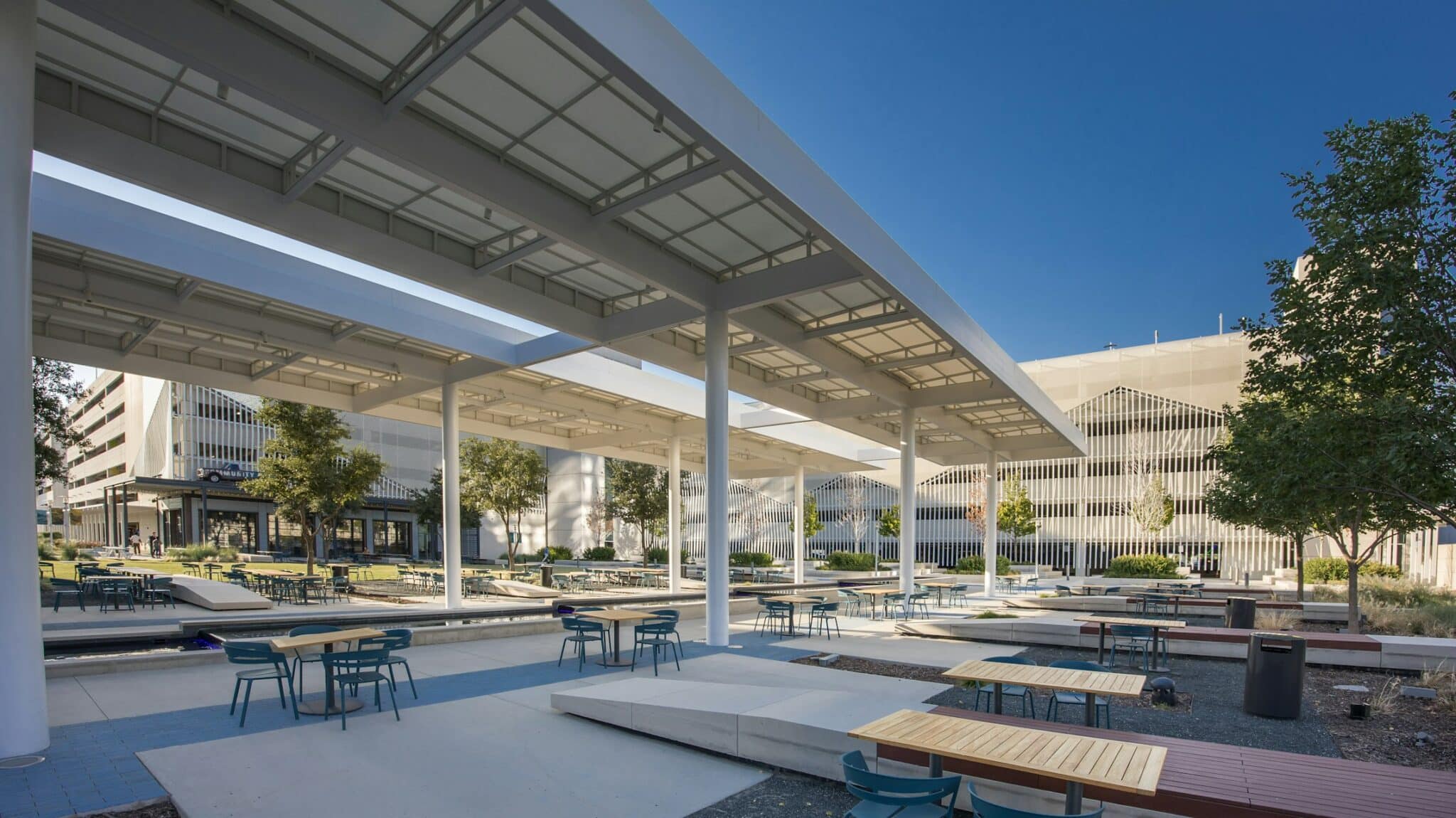 A wide view of the courtyard with the facade blending in yet elevating the area.